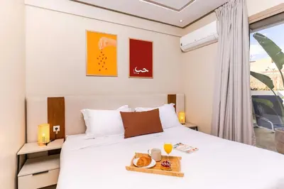 a bedroom with a bed with a tray of food on it at Lalla Homes 369 in Marrakech