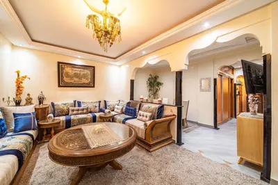 a living room with a couch and a table at Spacious & Modern Guéliz Apart - 5 min to Airport in Marrakech