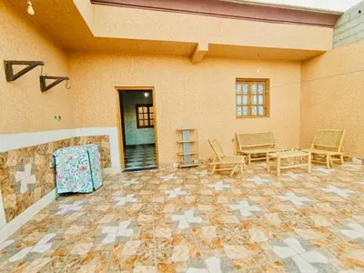a large room with chairs and a table in a room at Nice apart wi-fi 3rd floor in El Gouassem