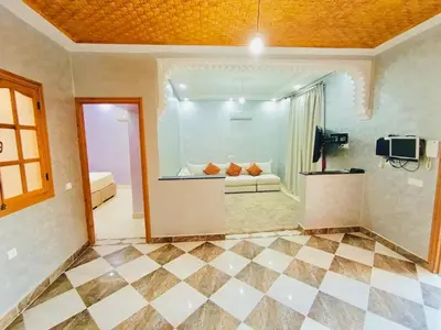 a living room with a couch and a tv in a room at Nice apart wi-fi 3rd floor in El Gouassem