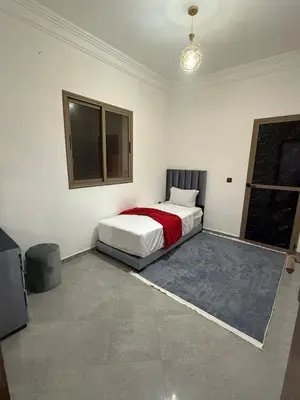 a bedroom with a bed in the corner of a room at Marrakech appartement in Marrakech