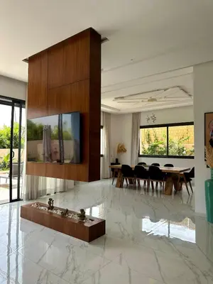 a living room with a dining room table and chairs at Exceptional Villa Noria Golf in Marrakech