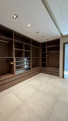 a large room with wooden cabinets and a large tile floor at Luxury villa Noria golf club in Marrakech