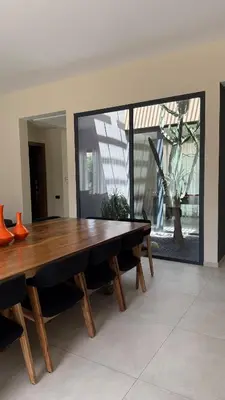 a wooden table in a room with a large window at Luxury villa Noria golf club in Marrakech