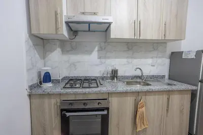 a kitchen with a sink and a stove at Family apartment Jardins Chrifia in Marrakech