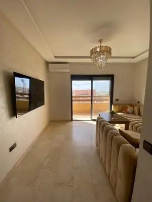 a living room with a couch and a chandelier at Appartement moderne confortable 2 chambres près de Marrakech Gueliz piscine in Marrakech