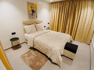 a bedroom with a large bed and a window at Appartement Cozy Hivernage in Marrakech