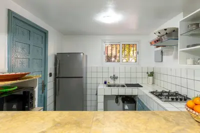 a kitchen with a refrigerator and a sink at Riad Qarya Petit-déjeuner et transfert inclus in Marrakech