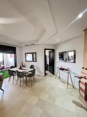 a living room with a table and chairs at Quite place for your vacation in Marrakech