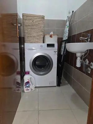 a washing machine in a bathroom with a sink at Quiet and comfortable apartment in Marrakech