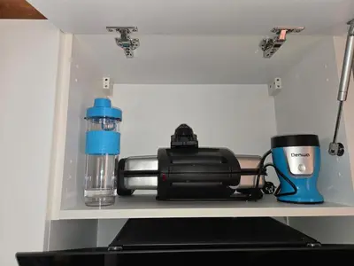 a shelf with a coffee maker and a bottle of water at Quiet and comfortable apartment in Marrakech