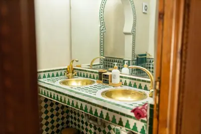 a bathroom with two sinks and a mirror at la roseraie Marrakech in Marrakech