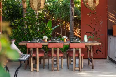 a wooden table with red chairs and a tableasteryasteryasteryasteryasteryasteryastery at Oasis Privée - Dar Lola in Marrakech