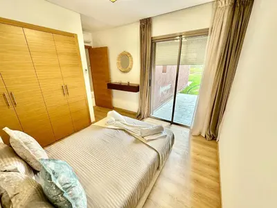 a bedroom with a bed and a large window at Comfy Luxe Stay Golf View Marrakech in Marrakech