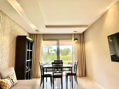 a dining room with a table and chairs at Comfy Luxe Stay Golf View Marrakech in Marrakech