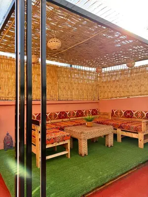 a room with couches and a table in a room with grass at Riad Authentique à quelques pas de Jamaa El-Fna in Marrakech