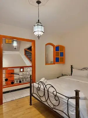 a bedroom with a bed and a large mirror at Riad Authentique à quelques pas de Jamaa El-Fna in Marrakech