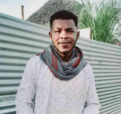 a man wearing a scarf and a gray shirt at السودان in Marrakech