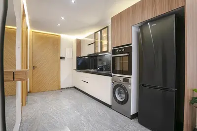 a kitchen with a refrigerator and a washer and dryer at A Spot With No Rush - Marrakech in Marrakech