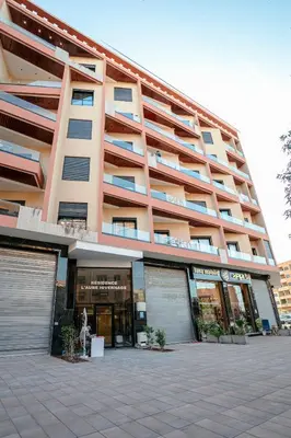 a large apartment building with a parking lot in front of it at The Right Address - Hivernage Marrakech in Marrakech
