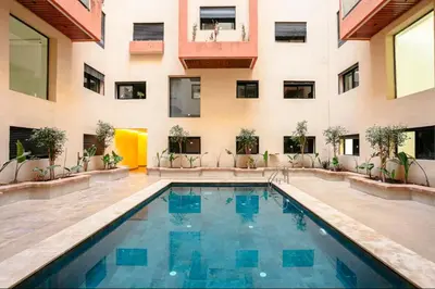 a swimming pool in the middle of a building at The Cozy Corner - Hivernage Marrakech in Marrakech