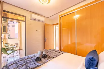 a bedroom with a bed and a sliding glass door at Appartement chic et confortable au cœur de Gueliz in Marrakech