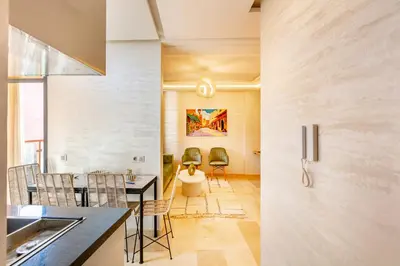 a kitchen and dining room with a table and chairs at Appartement chic et confortable au cœur de Gueliz in Marrakech