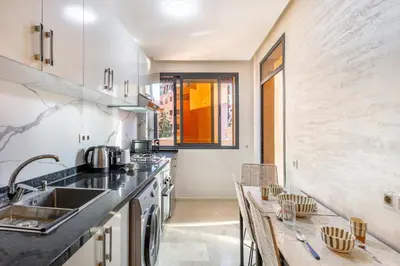 a kitchen with a sink and a counter top at Appartement chic et confortable au cœur de Gueliz in Marrakech