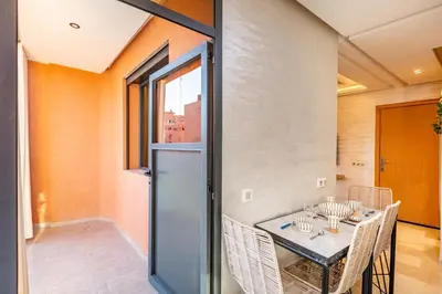 a dining room with a table and chairs at Appartement chic et confortable au cœur de Gueliz in Marrakech