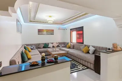 a living room with a couch and a table at Cosy 2BR Appartment, in City Center, AC, Iptv in Marrakech