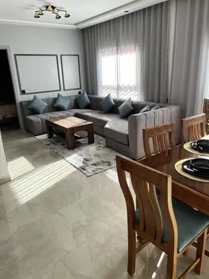 a living room with a couch and a table at Beautiful suite Apartment in the heart of Marrakech in Marrakech