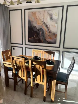 a dining room with a wooden table and chairs at Beautiful suite Apartment in the heart of Marrakech in Marrakech