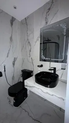 a bathroom with a black sink and a toilet at Beautiful suite Apartment in the heart of Marrakech in Marrakech