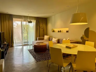 a room with a bed and a table and a couch at Suites 25, Hivernage, Calme, 2BR, Marrakech in Marrakech