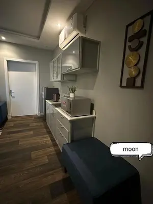 a small room with a kitchen with a microwave at شقة مروان in Marrakech