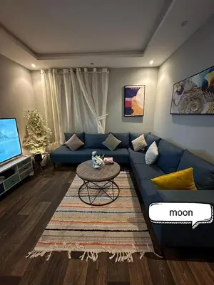 a living room with a blue couch and a table at شقة مروان in Marrakech