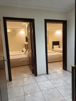 a room with two mirrors and a room with two beds at شقة مروان in Marrakech