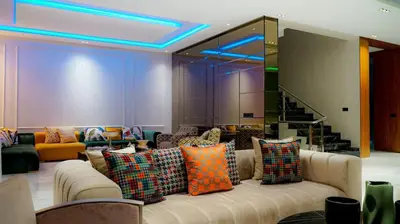 a living room with a couch with colorful pillows at villa argana golf in Marrakech