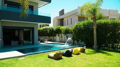 a yard with chairs and a swimming pool in a house at villa argana golf in Marrakech