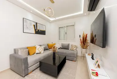 a living room with a couch and a table at Red City Elegant Stay in Marrakech