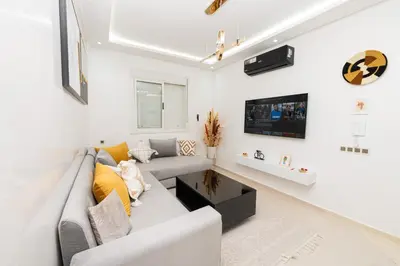 a living room with a couch and a tv at Red City Elegant Stay in Marrakech