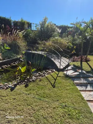 a garden with a bench in the grass at Oasis Of peace Chalet A-frame Atlas view in Aït Amara