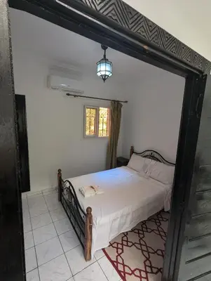 a bedroom with a bed and a window at Almohafidon room 2 in Marrakech