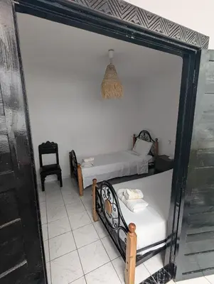 a room with two beds and a mirror at Almohafidon room 2 in Marrakech