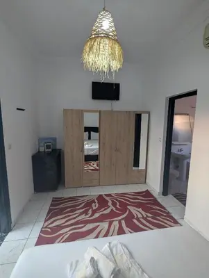 a room with a bed and a mirror and a chandelier at Almohafidon room 2 in Marrakech