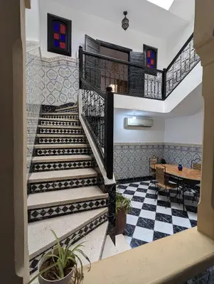 a staircase in a house with a checkered floor at Almohafidon room 2 in Marrakech
