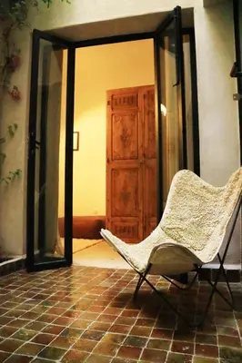 a white chair sitting in front of a mirror at Dar Helen in Marrakech