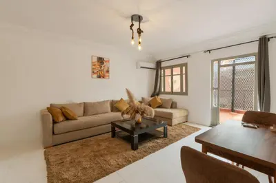 a living room with a couch and a table at Modern studio with terrace in Marrakech