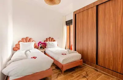 a bedroom with two beds and a wooden wall at Premium Holliday Marrakesh in Marrakech