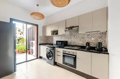 a kitchen with a stove and a washer and dryer at Premium Holliday Marrakesh in Marrakech